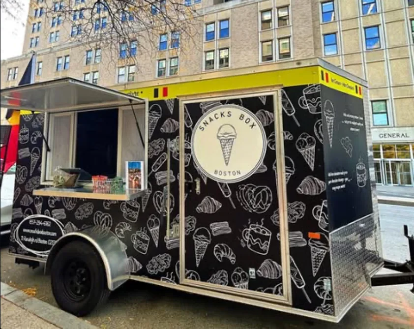 SNACKSBOX Boston team serving guests at a catering event